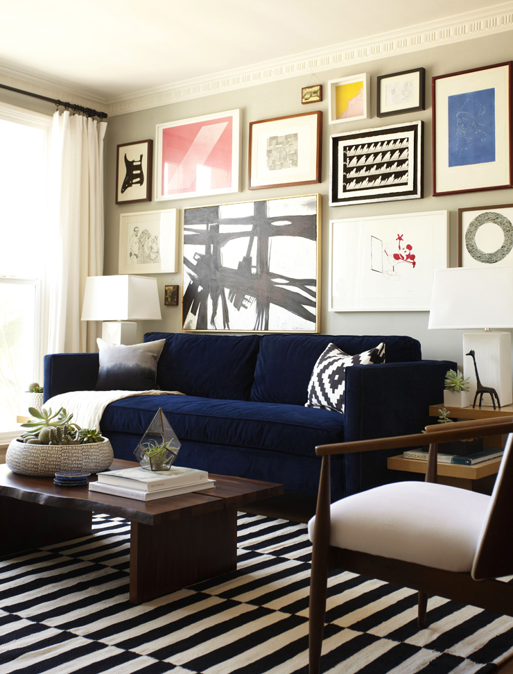 Blue velvet couch and gallery wall