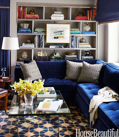 Blue velvet couch with patterned rug