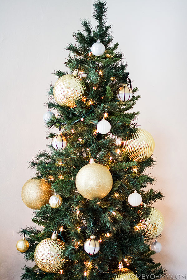 Skinny Christmas tree with large gold ornaments.  Great for big impact in a small space!