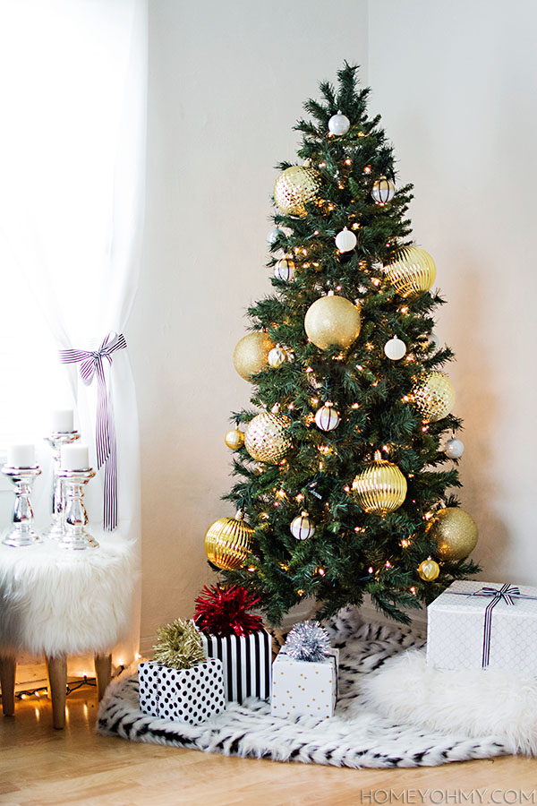 Skinny Christmas tree with large gold ornaments.  Great for big impact in a small space!