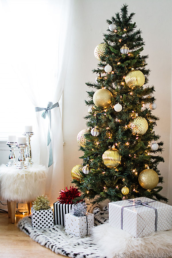 Skinny Christmas tree with large gold ornaments.  Great for big impact in a small space!