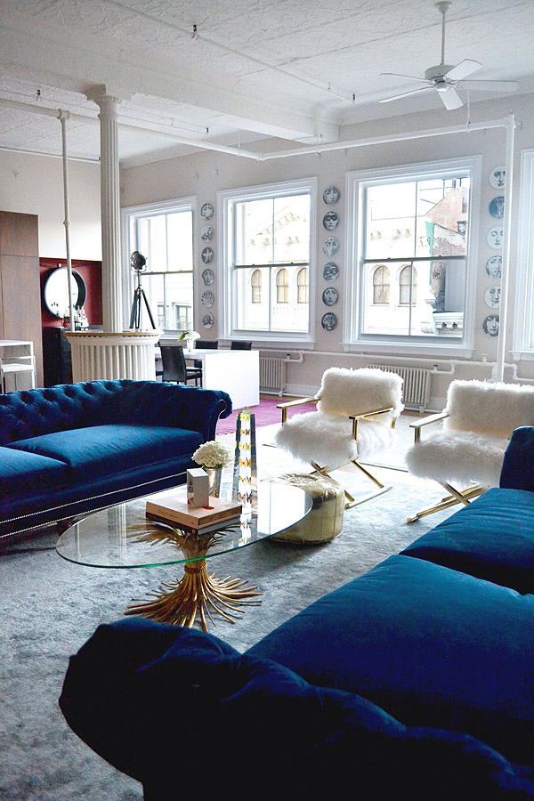 Soho-NYC-loft-Tamra-Sanford-living-room-fuzzy-chairs-blue-velvet-sofas-windows